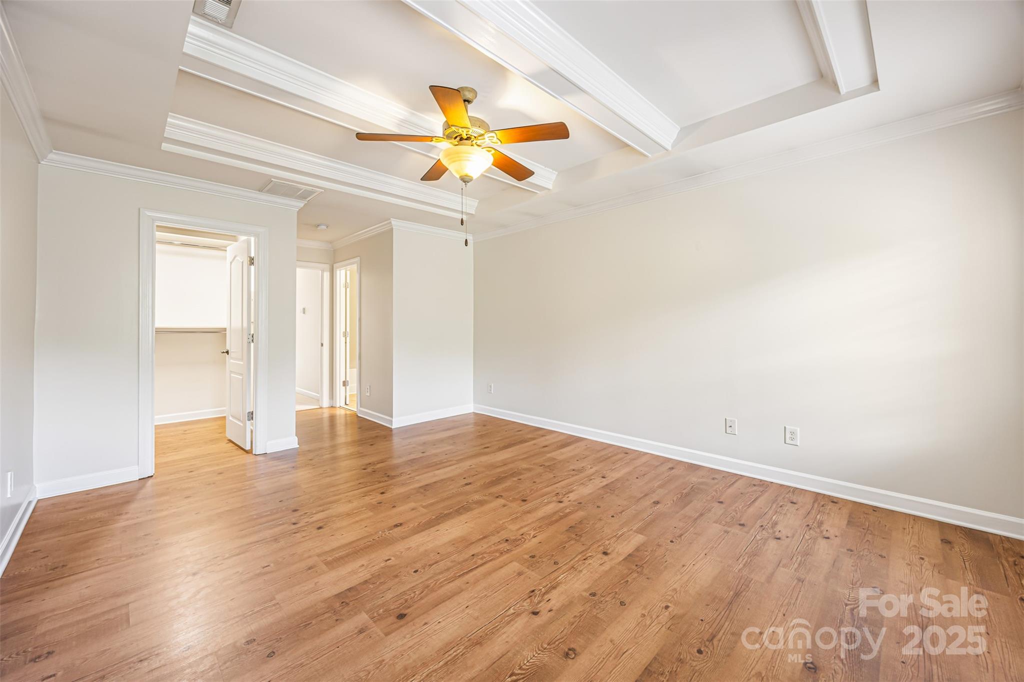 6729 Dusty Saddle Road Charlotte, NC 28277 - Photo 30 of 44 an empty room with wooden floor fan and windows