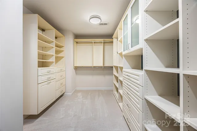 a view of walk in closet and bedroom