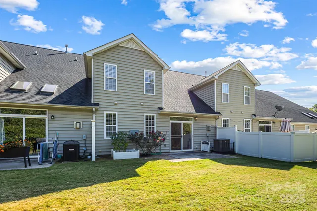a view of a house with a swimming pool and a yard