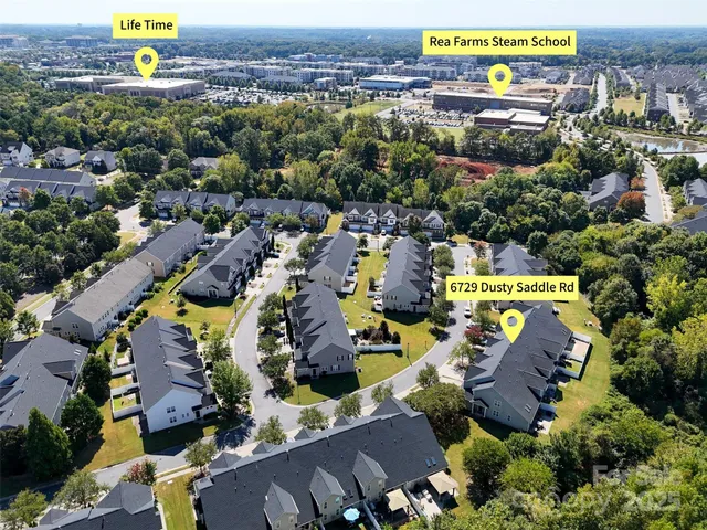 an aerial view of swimming pool patio and outdoor seating