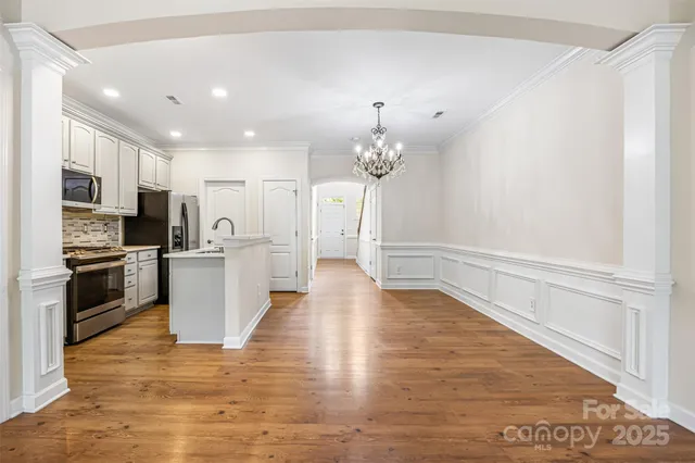 a view of kitchen with sink microwave refrigerator and stove