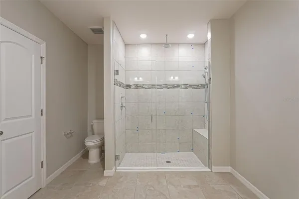 a view of a bathroom with toilet shower and a yard