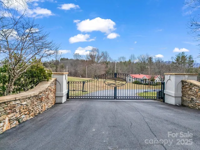 a view of a fence and a trees in the background
