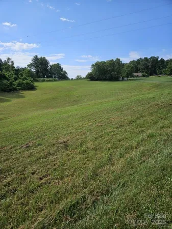 a view of a field with an ocean
