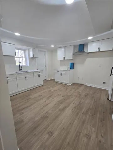 a view of a kitchen with wooden cabinets