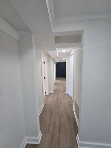 a view of a hallway with wooden floor