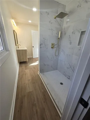 a bathroom with a sink a toilet and shower