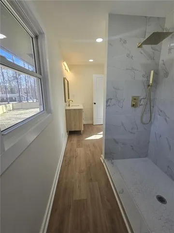 a bathroom with a sink a toilet and shower