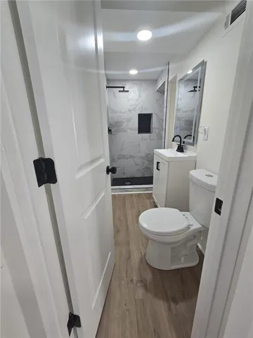 a bathroom with a toilet and a shower