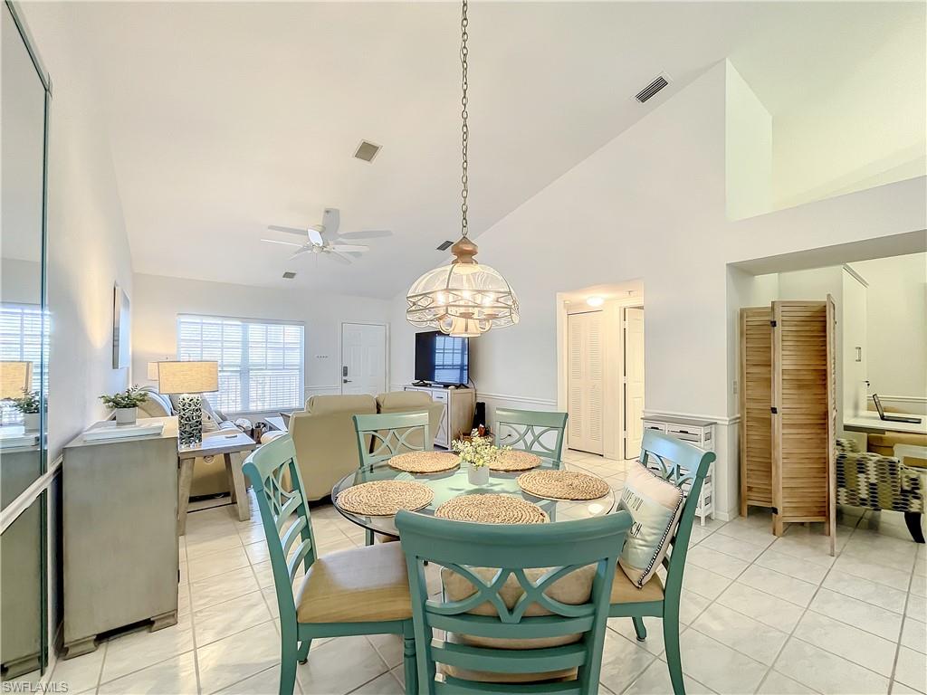 470 Bermuda Cove Way, Unit 2303 Naples, FL 34110 - Photo 13 of 48 a view of a dining room with furniture