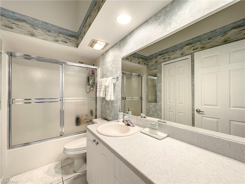 470 Bermuda Cove Way, Unit 2303 Naples, FL 34110 - Photo 17 of 48 a bathroom with a sink toilet and shower