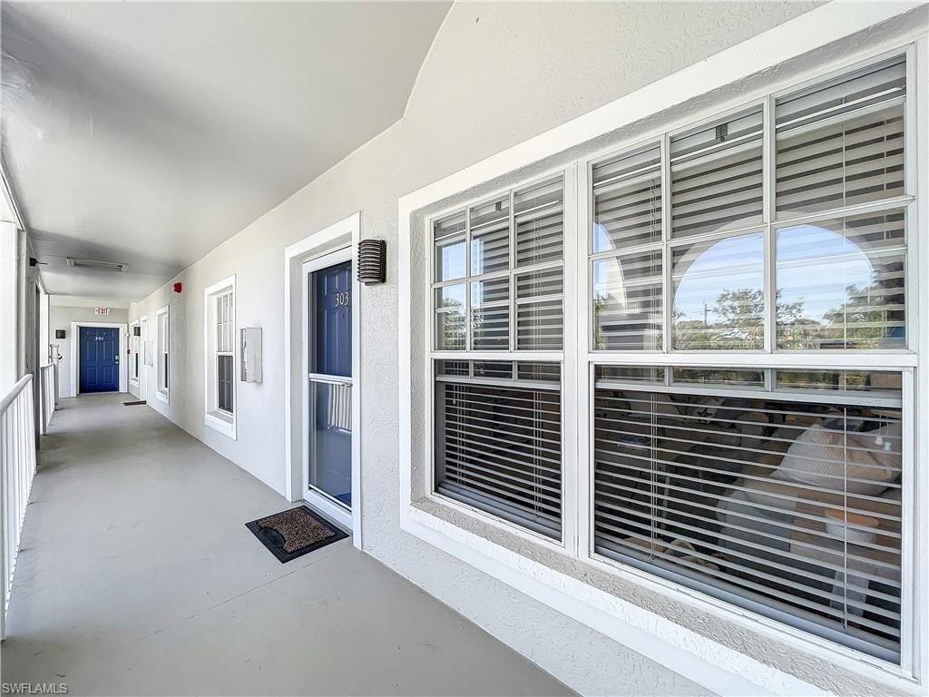 470 Bermuda Cove Way, Unit 2303 Naples, FL 34110 - Photo 20 of 48 a view of a balcony and floor to ceiling window