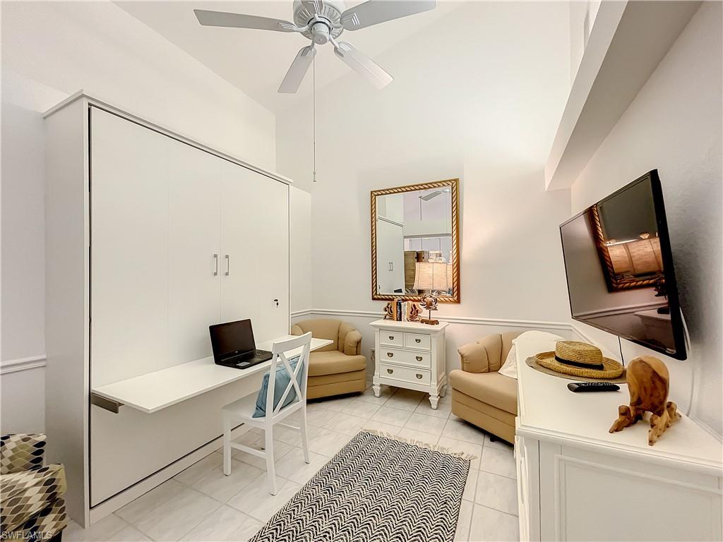 470 Bermuda Cove Way, Unit 2303 Naples, FL 34110 - Photo 21 of 48 a living room with furniture and a flat screen tv