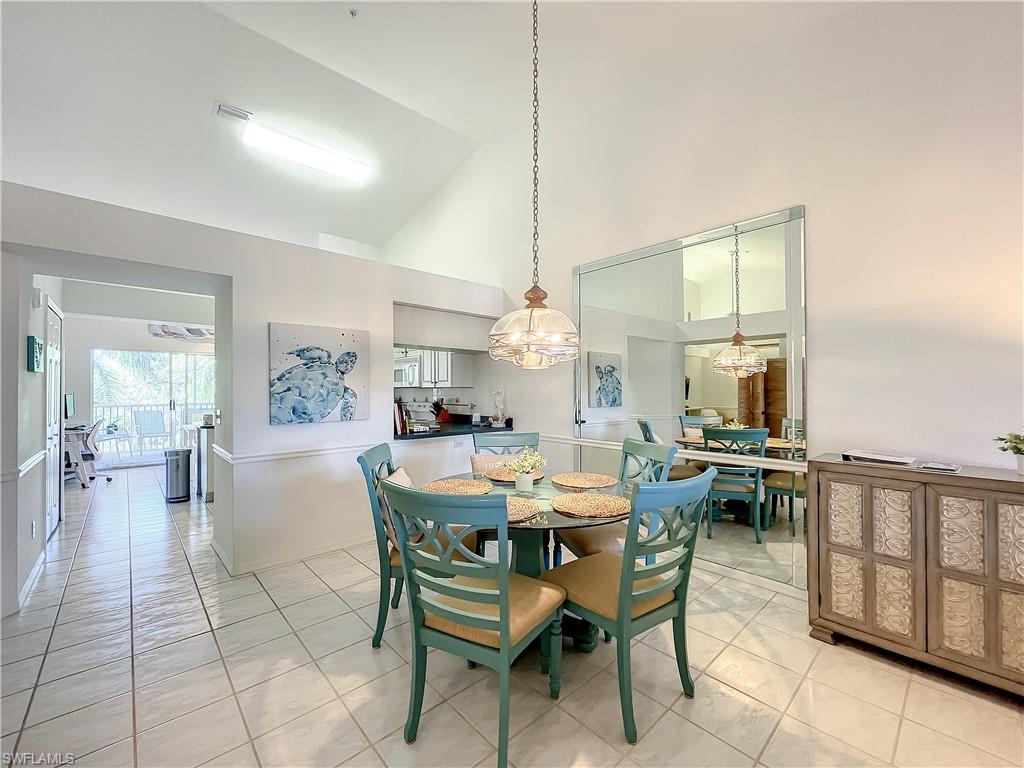 470 Bermuda Cove Way, Unit 2303 Naples, FL 34110 - Photo 23 of 48 a dining room with furniture and wooden floor