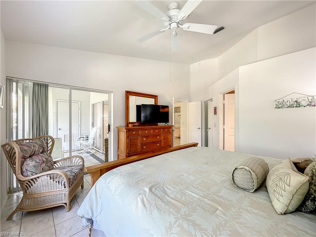 470 Bermuda Cove Way, Unit 2303 Naples, FL 34110 - Photo 26 of 48 a bedroom with a bed and a television