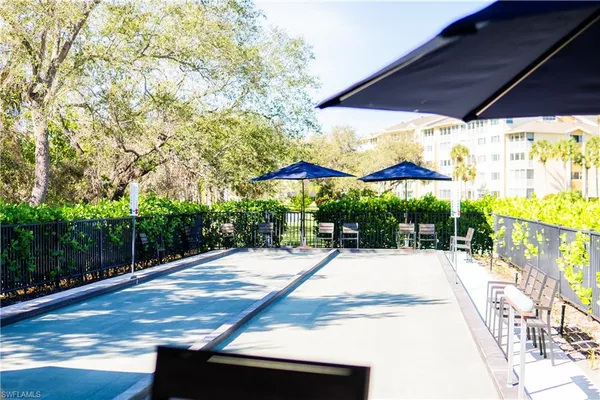 a view of patio with a table and chairs under an umbrella