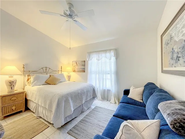 a bedroom with a bed couch and window