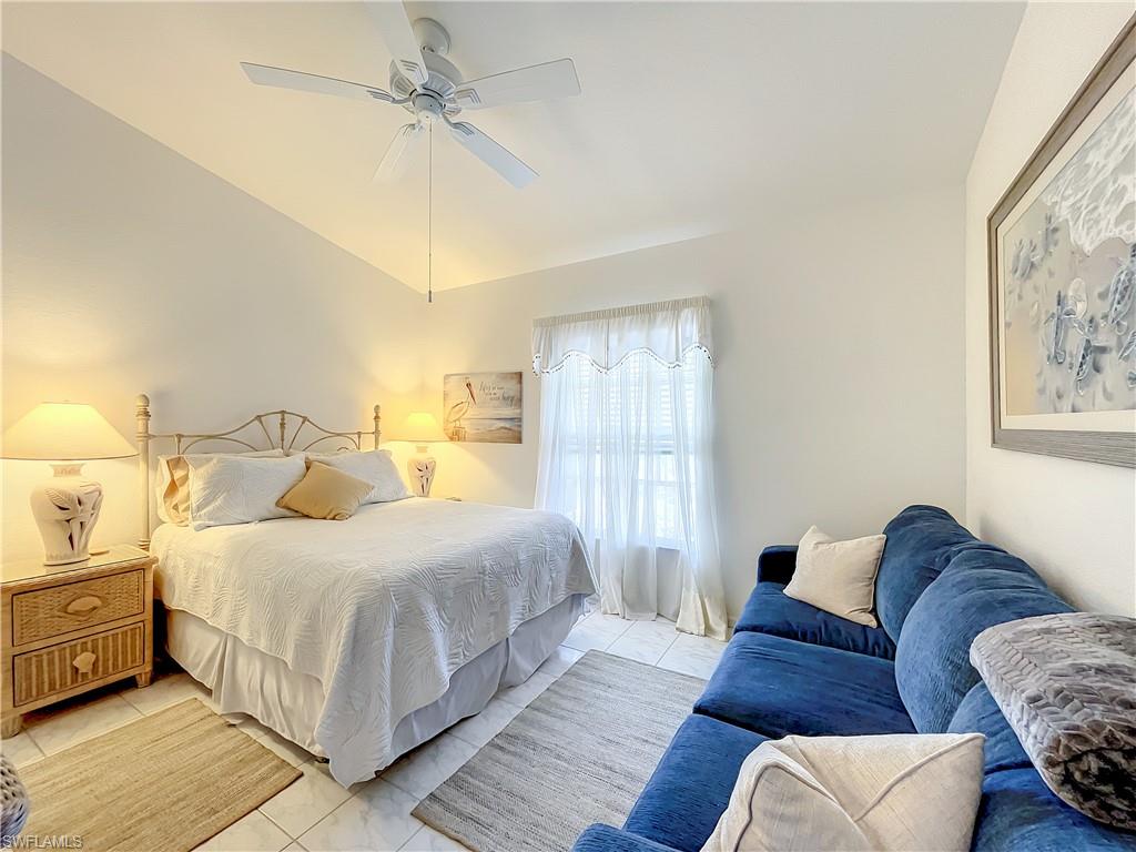 470 Bermuda Cove Way, Unit 2303 Naples, FL 34110 - Photo 31 of 48 a bedroom with a bed couch and window