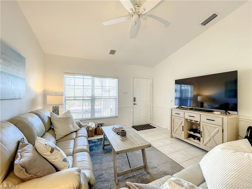 470 Bermuda Cove Way, Unit 2303 Naples, FL 34110 - Photo 36 of 48 a living room with furniture and a flat screen tv