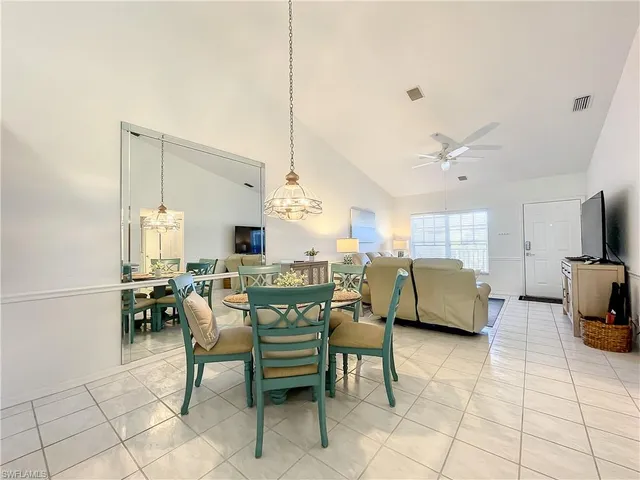 a dining room with furniture and a view of kitchen