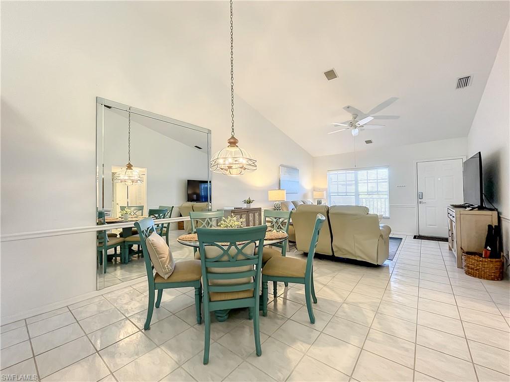 470 Bermuda Cove Way, Unit 2303 Naples, FL 34110 - Photo 39 of 48 a dining room with furniture and a view of kitchen