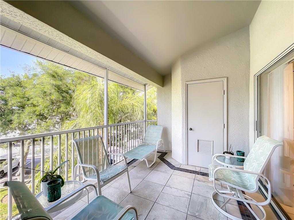 470 Bermuda Cove Way, Unit 2303 Naples, FL 34110 - Photo 47 of 48 a living room with furniture and floor to ceiling windows