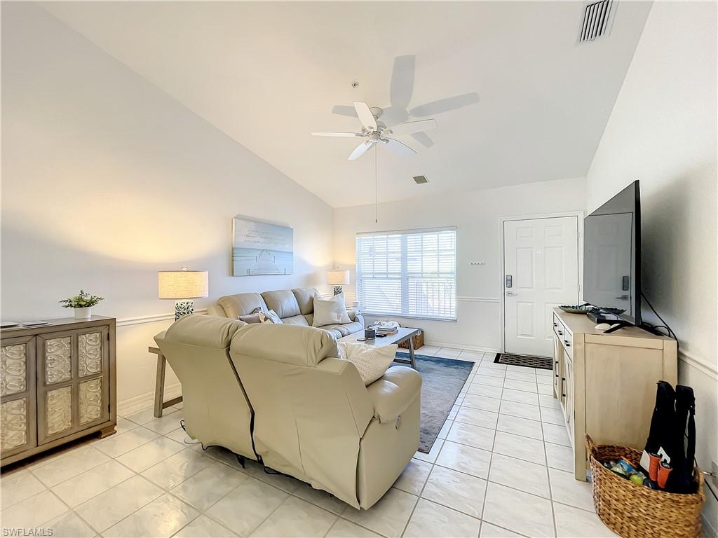 470 Bermuda Cove Way, Unit 2303 Naples, FL 34110 - Photo 8 of 48 a living room with furniture and a flat screen tv
