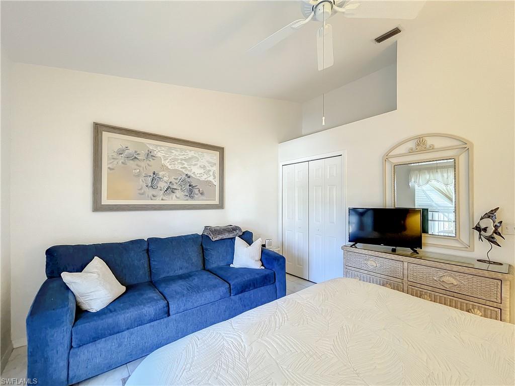 470 Bermuda Cove Way, Unit 2303 Naples, FL 34110 - Photo 10 of 48 a living room with furniture and a flat screen tv