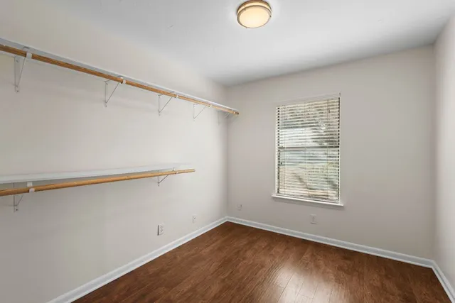 a view of a room with wooden floor and cabinet