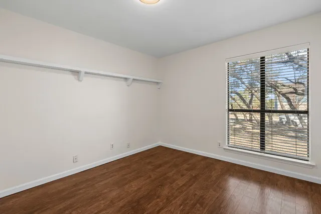 a view of a room with wooden floor and windows
