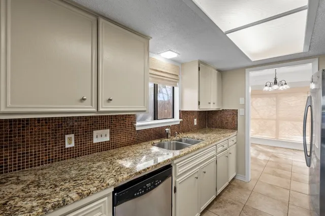 a kitchen with stainless steel appliances granite countertop a sink stove and cabinets