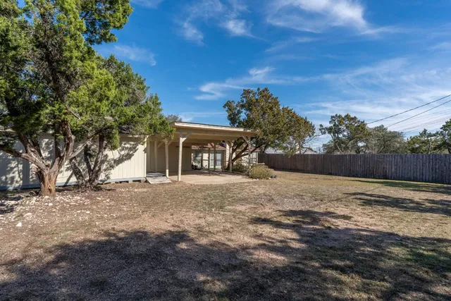 a view of a house with a yard and garage