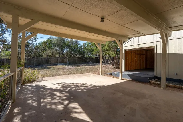 a backyard of a house with basket ball court and floor to ceiling window