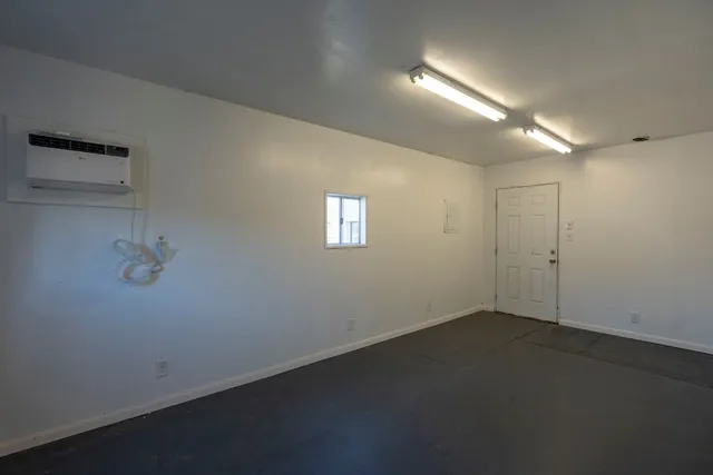 an empty room with a empty space and windows