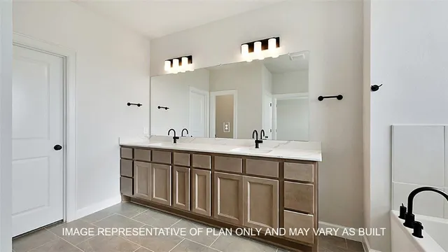 a spacious bathroom with a double vanity sink and a mirror