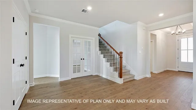 a view of an entryway with wooden floor