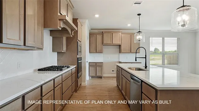 a kitchen with stainless steel appliances granite countertop a sink stove and cabinets