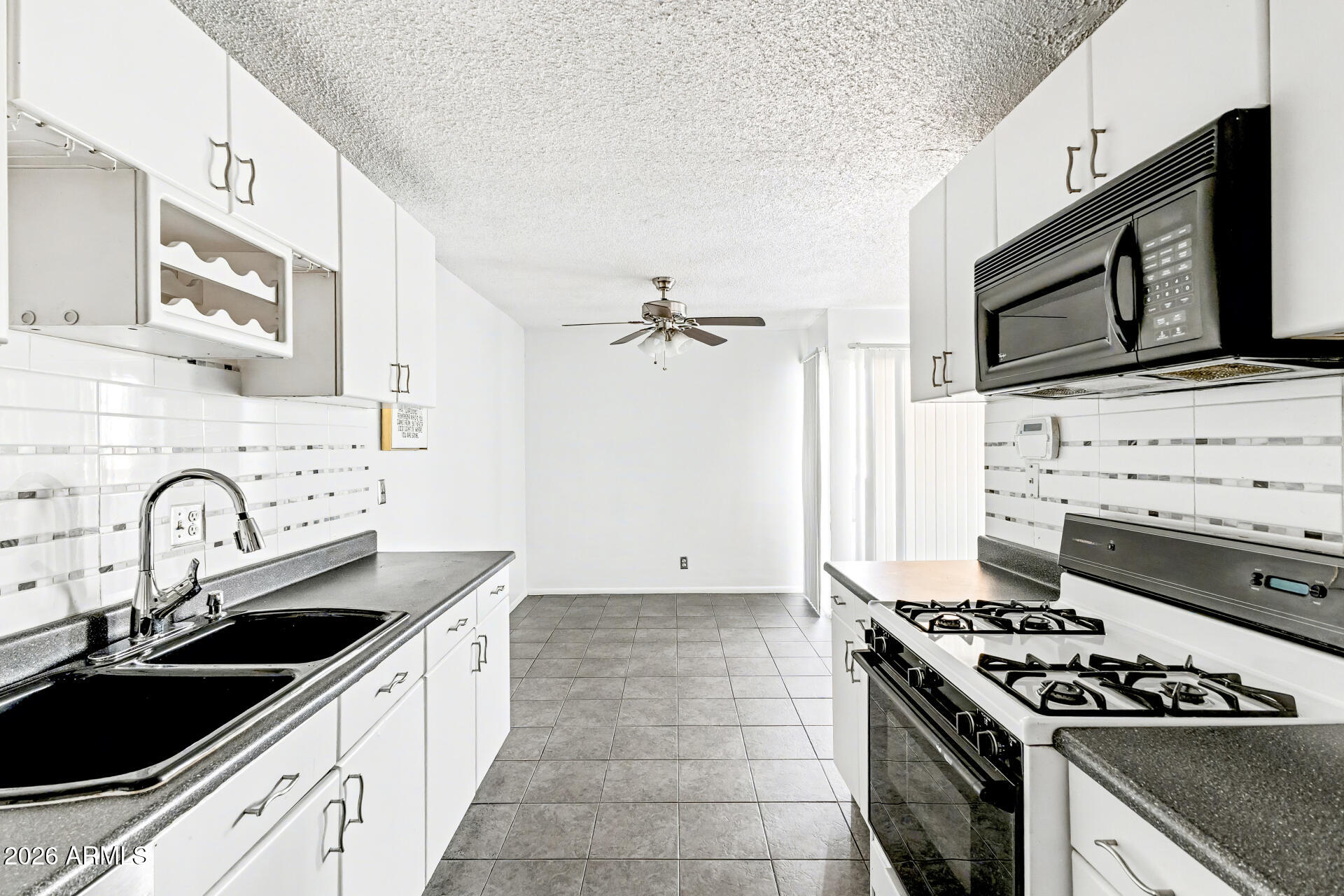 6767 North 7th Street, Unit 217 Phoenix, AZ 85014 - Photo 10 of 31 a kitchen with granite countertop a stove top oven sink and cabinets