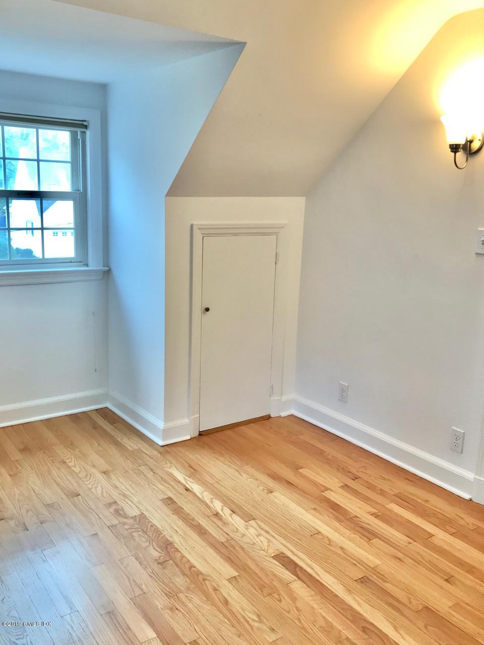 7 River Lane Cos Cob, CT 06807 - Photo 13 of 21 a view of an empty room with wooden floor and a window