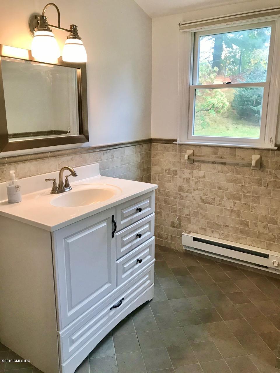 7 River Lane Cos Cob, CT 06807 - Photo 15 of 21 a bathroom with a sink a vanity and a mirror