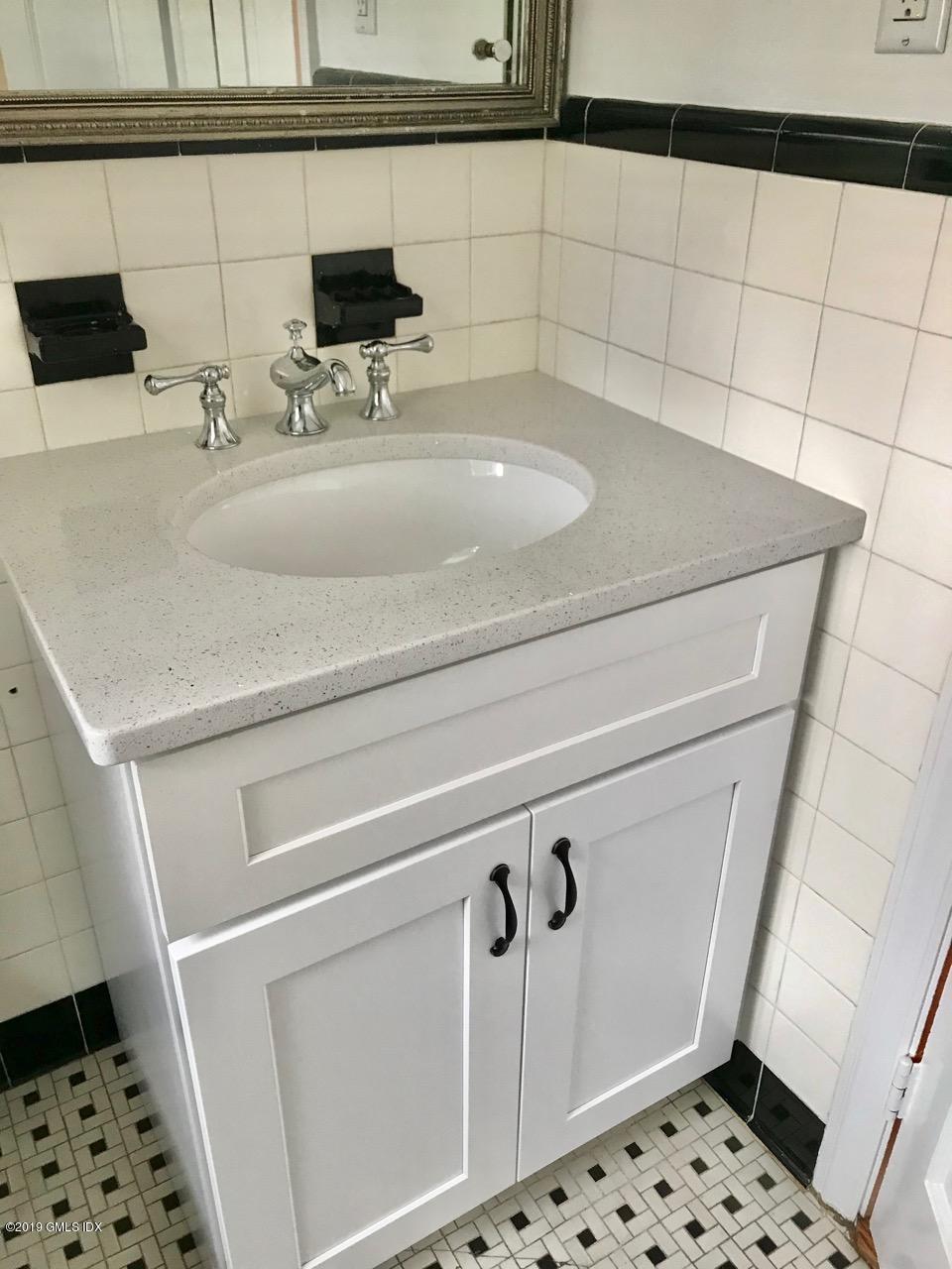 7 River Lane Cos Cob, CT 06807 - Photo 17 of 21 a bathroom with a sink and a mirror