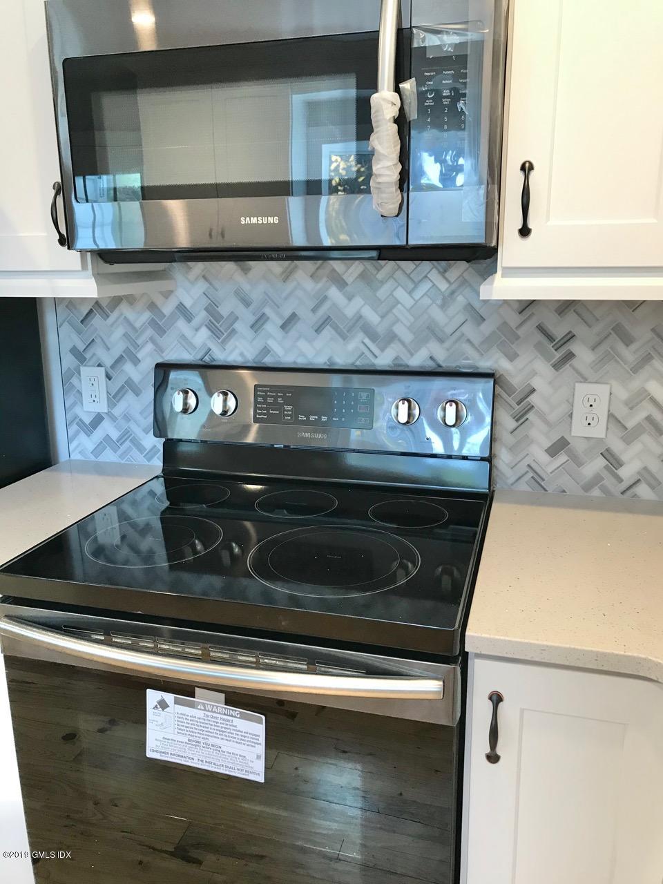 7 River Lane Cos Cob, CT 06807 - Photo 5 of 21 a close view of stove with granite counter top