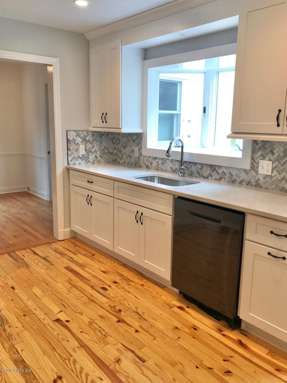 7 River Lane Cos Cob, CT 06807 - Photo 8 of 21 a kitchen with granite countertop a sink cabinets and wooden floor