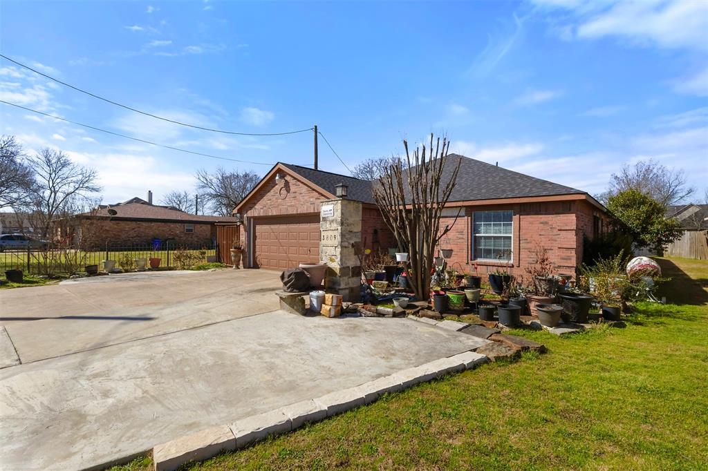 3809 Peachtree Road Balch Springs, TX 75180 - Photo 2 of 27 View of front of home featuring fence, driveway, roof with shingles, a front lawn, and brick siding