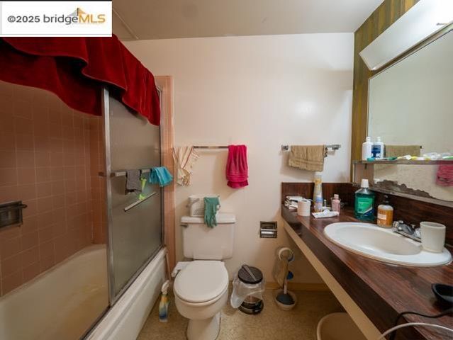 a bathroom with a sink mirror vanity and toilet
