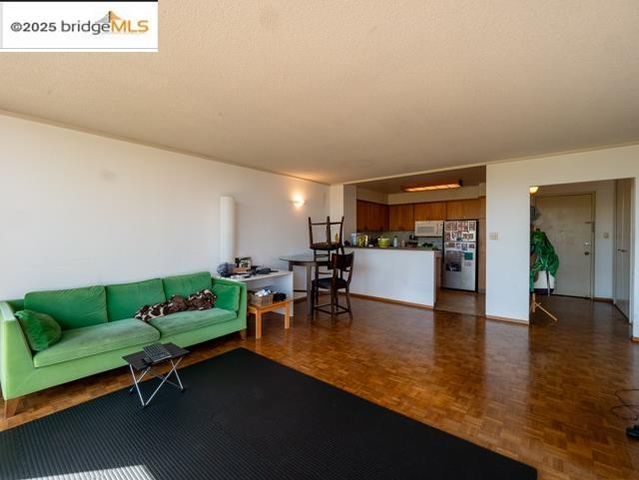 a living room with furniture and kitchen view