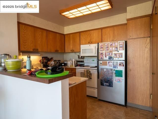 a kitchen with a refrigerator a stove a sink and a window