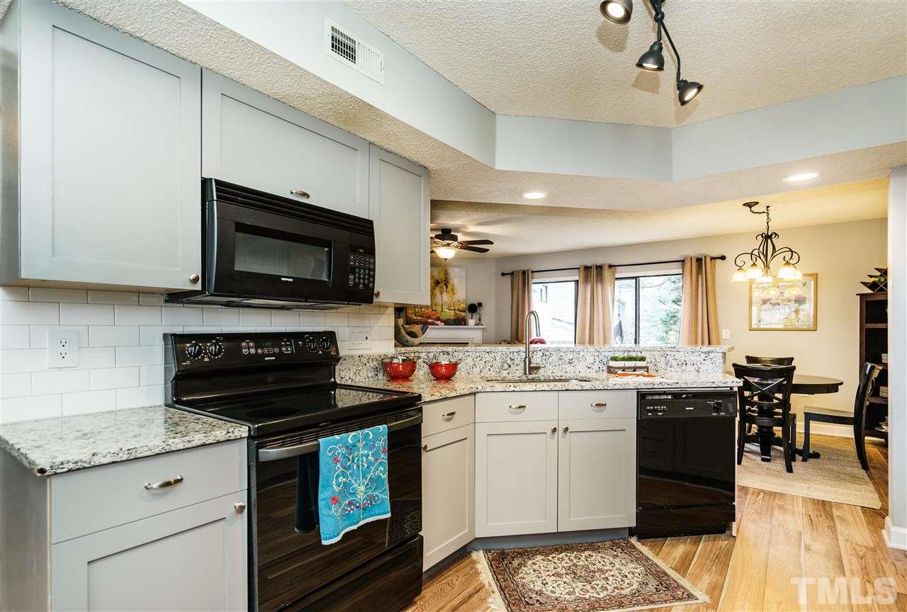 7634 Falcon Rest Circle, Unit 7634 Raleigh, NC 27615 - Photo 12 of 25 a kitchen with a stove sink and microwave