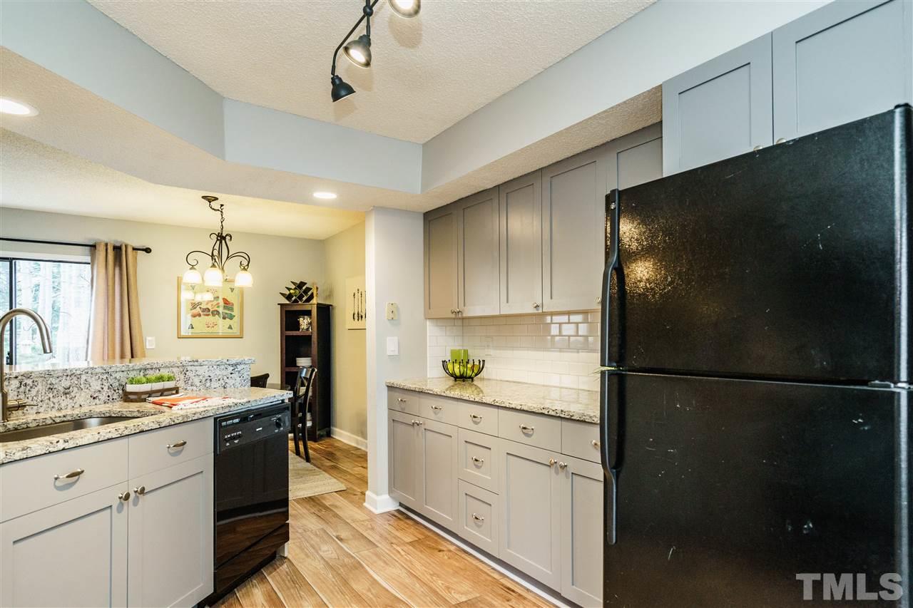 7634 Falcon Rest Circle, Unit 7634 Raleigh, NC 27615 - Photo 13 of 25 a kitchen with a refrigerator and a sink