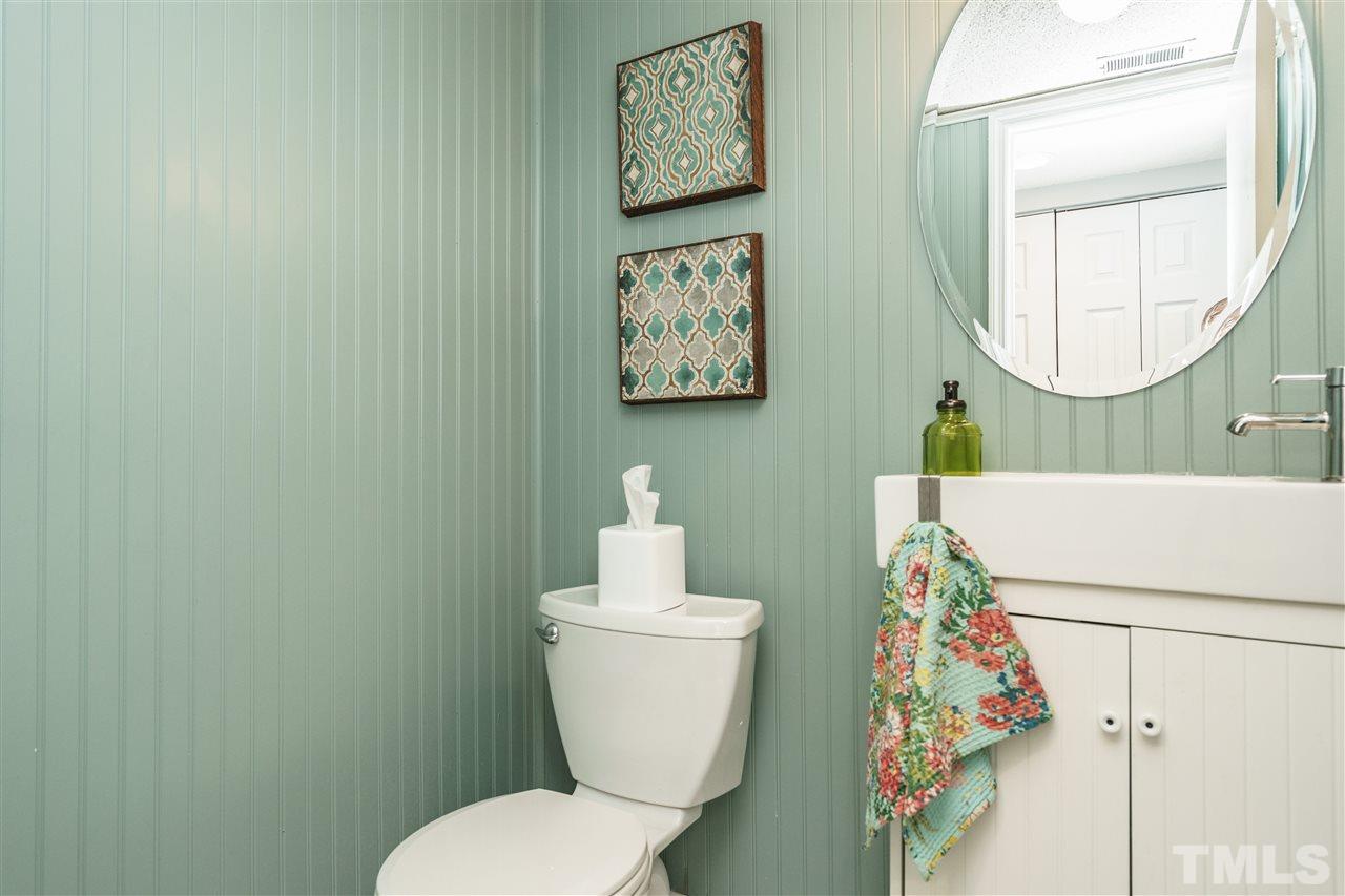 7634 Falcon Rest Circle, Unit 7634 Raleigh, NC 27615 - Photo 15 of 25 a bathroom with a toilet a sink and a mirror